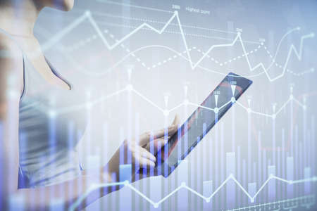 Double exposure of forex chart sketch hologram and woman holding and using a mobile device. Stock...