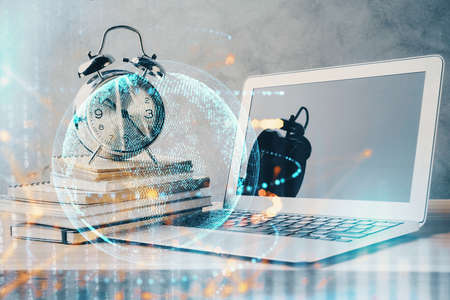 Double exposure of desktop with computer and world map hologram. International data network concept.