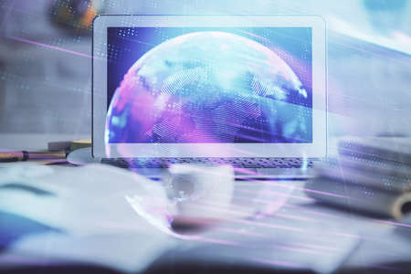 Computer on desktop in office with technology theme hologram. Double exposure. Tech concept.の写真素材