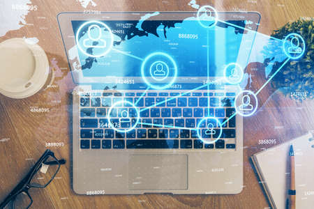 Computer on desktop with social network theme icon. Multi exposure. Concept of international...