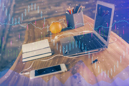 Double exposure of forex chart and work space with computer. Concept of international online trading.の写真素材