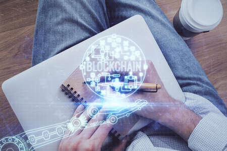 Mans hands working with notes background. Cryptocurrency and finance concept. Double exposure.