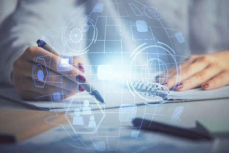Social network theme hologram over hands taking notes background. Concept of global international...