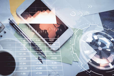 Multi exposure of forex graph hologram over desktop with phone. Top view. Mobile trade platform...