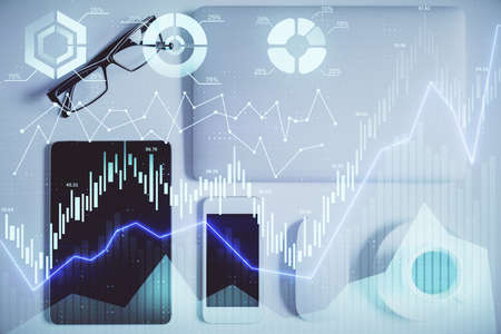 Double exposure of forex chart hologram over desktop with phone. Top view. Mobile trade platform...