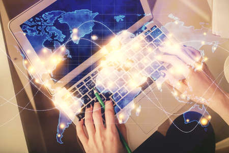 Double exposure of woman hands working on computer and financial theme hologram drawing. Top View....