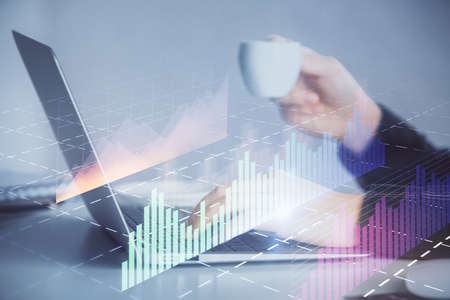 Double exposure of businesswoman hands typing on computer and forex graph hologram drawing....