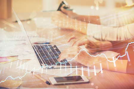 Multi exposure of woman hands typing on computer and financial chart hologram drawing. Stock market...