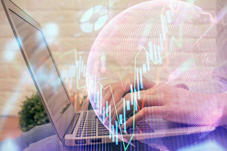 Multi exposure of woman hands typing on computer and forex chart hologram drawing. Stock market analysis concept.の写真素材