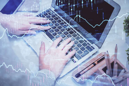 Multi exposure of woman hands typing on computer and forex chart hologram drawing. Stock market...
