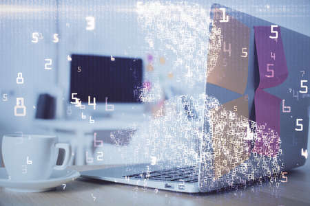 Computer on desktop in office with technology theme hologram. Double exposure. Tech concept.