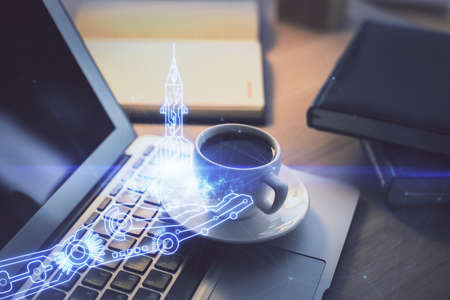 Desktop computer background in office and start up theme hologram drawing. Double exposure. Startup...