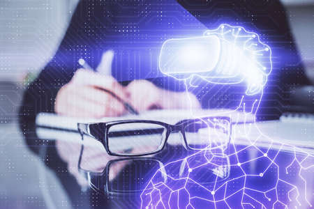 AR hologram over womans hands taking notes background. Concept of augmented reality. Multi exposureの写真素材