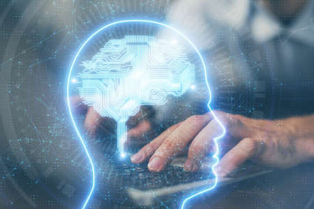 Businessman with computer background with brain theme hologram. Concept of brainstorm. Multi...