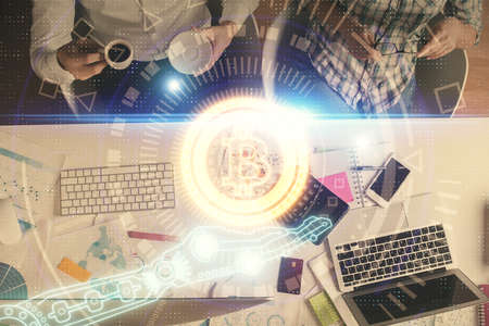 Double exposure of man and woman working together and crypto theme hologram drawing. Computer...