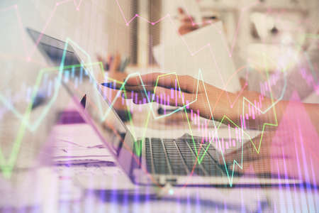 Multi exposure of woman hands typing on computer and financial graph hologram drawing. Stock market...