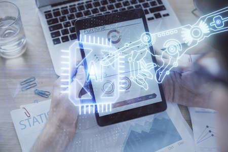 Double exposure of mans hand holding and using a digital device and data theme hologram drawing. Technology concept.の写真素材