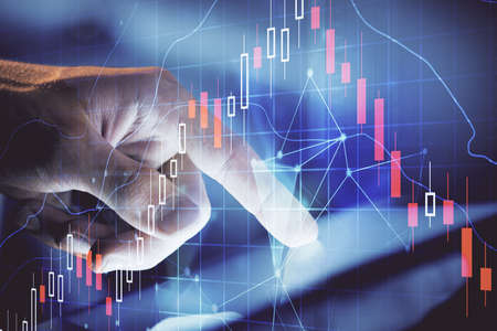 Multi exposure of mans hands holding and using a phone and financial chart drawing. Market analysis...