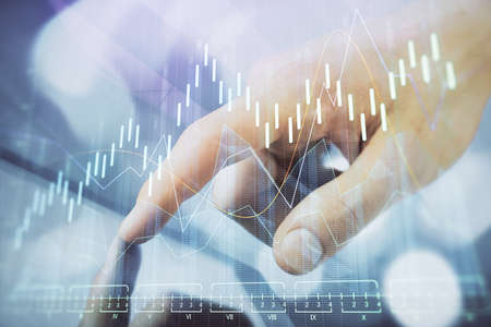 Multi exposure of mans hands holding and using a phone and financial chart drawing. Market analysis...