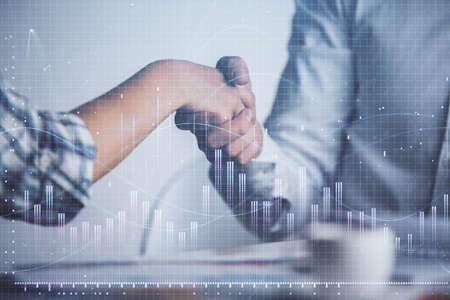 Double exposure of forex graph hologram and handshake of two men. Stock market concept.