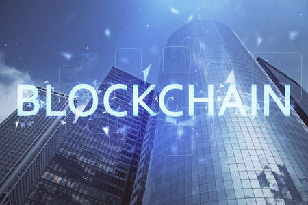 Double exposure of crypto currency theme hologram drawing and city veiw background. Concept of blockchain and bitcoin.の写真素材