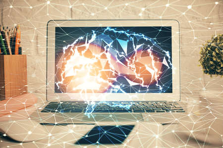 Double exposure of work space with computer and human brain drawing hologram. Brainstorm concept.の写真素材