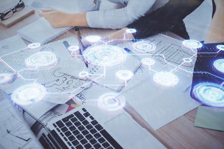 Social network theme hologram over hands taking notes background. Concept of global international...
