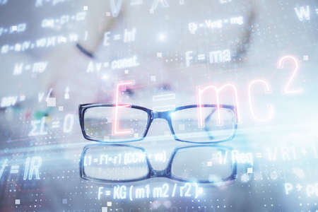 Science formula hologram over womans hands taking notes background. Concept of study. Multi exposureの写真素材