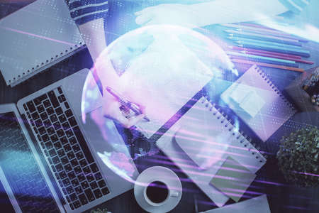 Tech theme hologram over womans hands taking notes background. Concept of hightech. Double exposure