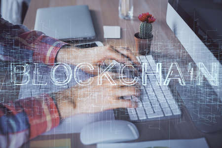 Blockchain theme hud with man working on computer on background. Concept of crypto chain. Double exposure.の写真素材