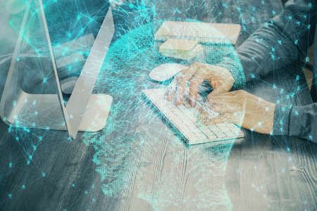 Man typing on keyboard background with brain hologram. Concept of big Data. Double exposure.の写真素材