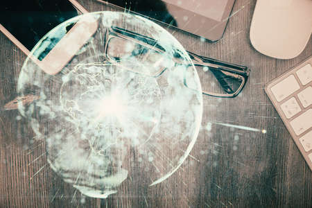 Double exposure of business theme hologram over desktop with phone. Top view. Mobile international...