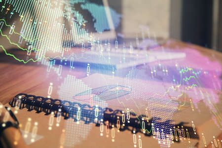 Double exposure of financial graph drawings and desk with open notebook background. Concept of forex...