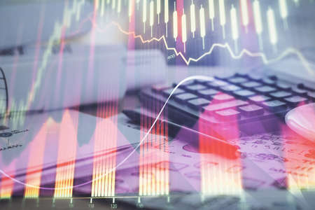 Double exposure of financial chart drawings and desk with open notebook background. Concept of forex...