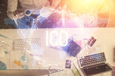 Double exposure of man and woman working together and crypto theme hologram drawing. Computer background. Blockchain concept. Top View.の写真素材