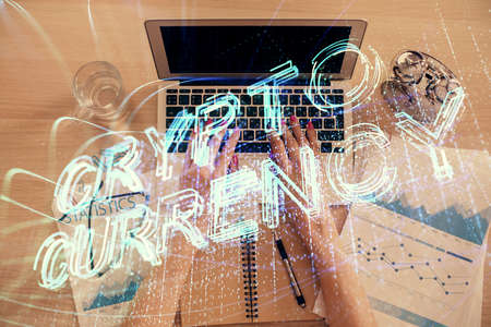 Double exposure of woman hands working on computer and blockchain theme hologram drawing. Top View. bitcoin cryptocurrency concept.の写真素材