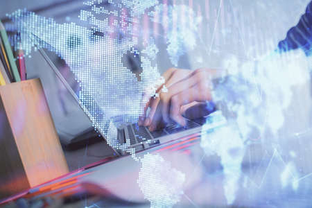 Double exposure of woman hands typing on computer and forex chart hologram drawing. Stock market...