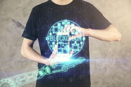 Double exposure of mans hands holding and using a phone and crypto currency blockchain theme...