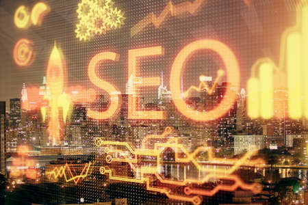 SEO hologram on city view with skyscrapers background double exposure. Search optimization concept.