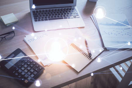 Computer on desktop with social network hologram. Double exposure. Concept of international people connections.の写真素材