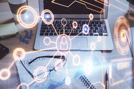 Computer on desktop with social network hologram. Double exposure. Concept of international people...