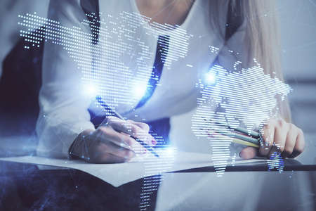 Social network theme hologram over hands taking notes background. Concept of global international...