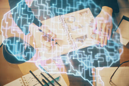 Multi exposure of womans writing hand on background with brain hologram. Concept of brainstorming.