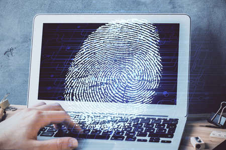 Fingerprint hologram with businessman working on computer on background. Security concept. Double exposure.の写真素材