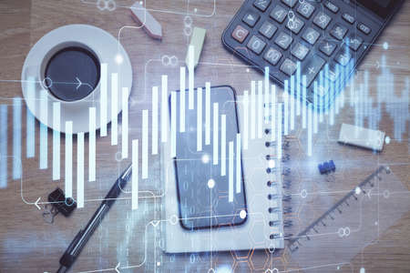 Multi exposure of forex graph hologram over desktop with phone. Top view. Mobile trade platform concept.の写真素材