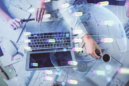 Double exposure of man and woman working together and technology theme drawing hologram. Big data concept. Computer background.の写真素材