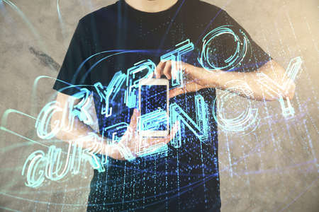Double exposure of mans hands holding and using a phone and crypto currency blockchain theme...