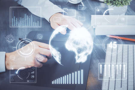 Double exposure of mans hands holding and using a phone and financial graph drawing. Analysis...