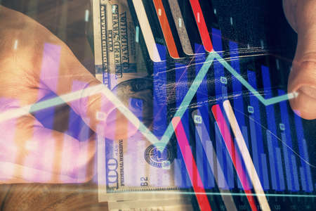 Multi exposure of forex graph drawing hologram and USA dollars bills and man hands. Technical...