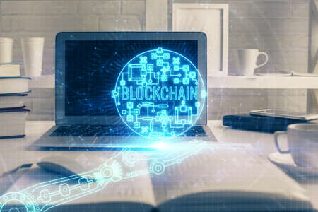 Multi exposure of blockchain theme hologram and table with computer background. Concept of bitcoin crypto currency.の写真素材